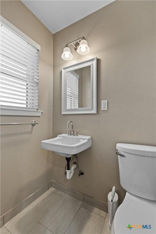 bathroom featuring tile patterned floors, toilet, and sink