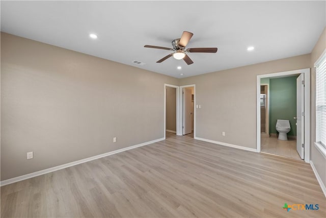 unfurnished bedroom with light wood-type flooring, connected bathroom, and ceiling fan