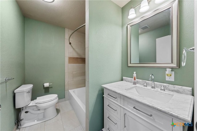 full bathroom with tile patterned floors, a textured ceiling, toilet, vanity, and tiled shower / bath