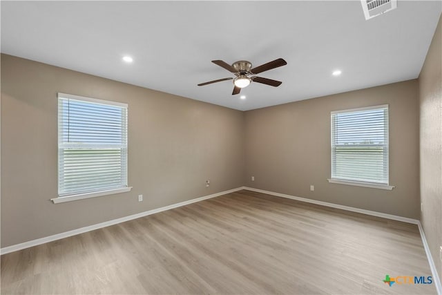 spare room with light hardwood / wood-style flooring and ceiling fan