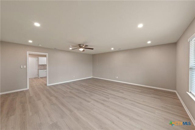 unfurnished room featuring ceiling fan and light hardwood / wood-style floors