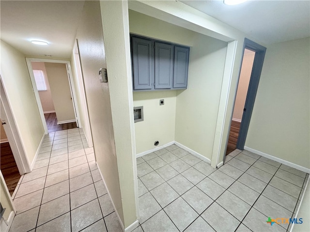 laundry room featuring hookup for an electric dryer, hookup for a washing machine, light tile patterned floors, and cabinets