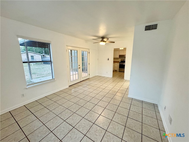 unfurnished room featuring ceiling fan, light tile patterned floors, and french doors