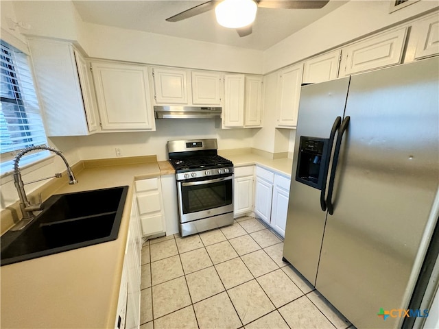 kitchen featuring stainless steel appliances, ceiling fan, sink, white cabinetry, and light tile patterned flooring