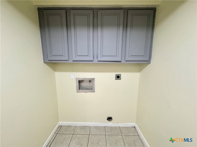 laundry area with electric dryer hookup, cabinets, light tile patterned floors, and hookup for a washing machine