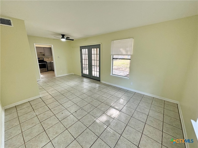 unfurnished room featuring french doors, light tile patterned floors, and ceiling fan