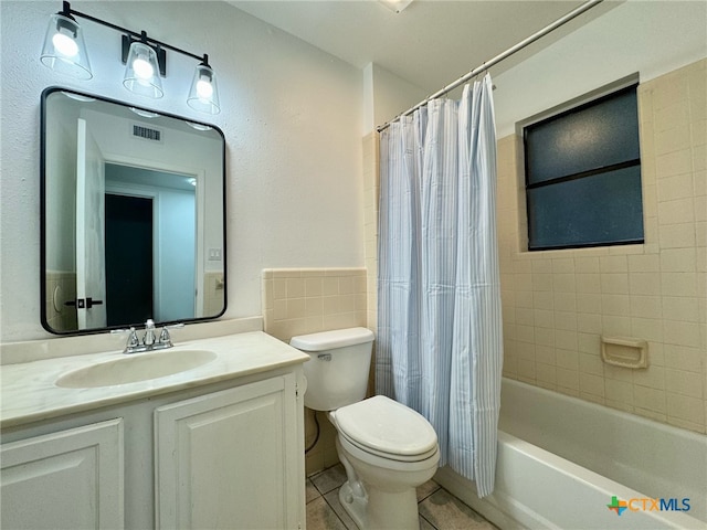 full bathroom with toilet, vanity, tile patterned floors, and shower / tub combo with curtain