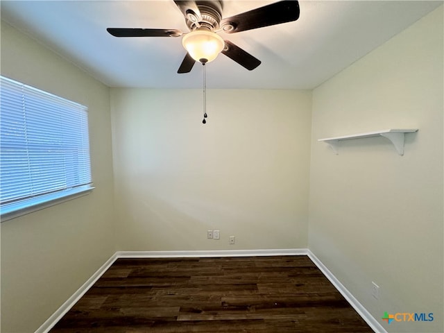 empty room with ceiling fan and dark wood-type flooring