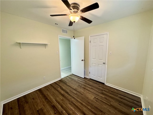 unfurnished bedroom with dark hardwood / wood-style floors and ceiling fan