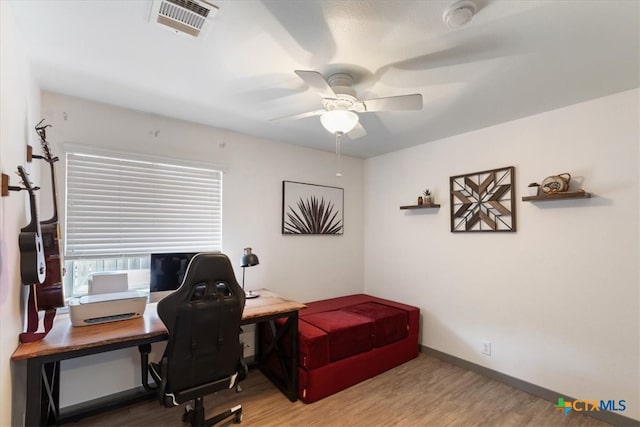 home office featuring hardwood / wood-style floors and ceiling fan