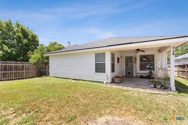 rear view of house featuring a lawn, ceiling fan, and a patio area