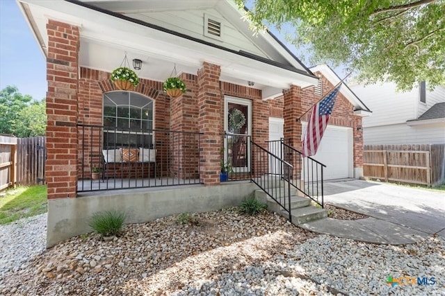 view of front of property with a garage and covered porch