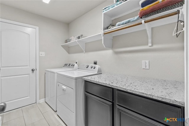 clothes washing area featuring cabinets, light tile patterned floors, and separate washer and dryer