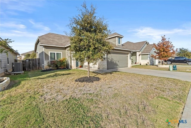 view of front of property featuring central air condition unit, a front yard, and a garage