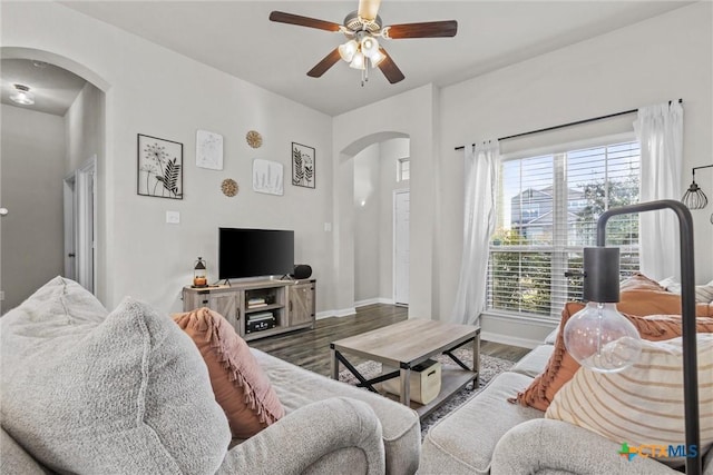 living room with ceiling fan and dark hardwood / wood-style floors