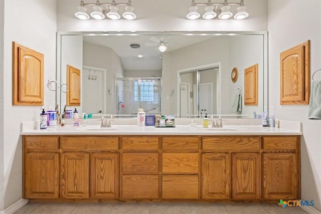 bathroom with tile patterned flooring, vanity, ceiling fan, and a shower with shower door