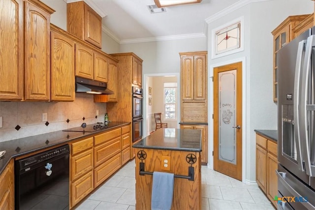 kitchen featuring a center island, crown molding, decorative backsplash, light tile patterned floors, and black appliances