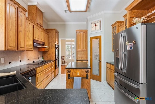 kitchen featuring black appliances, a kitchen island, light tile patterned flooring, and ornamental molding