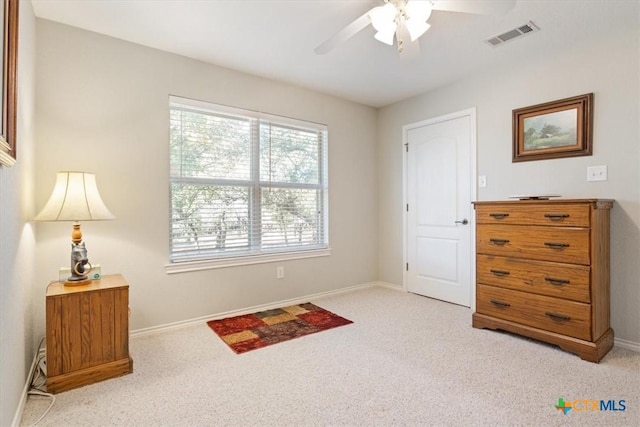 interior space featuring ceiling fan and light colored carpet