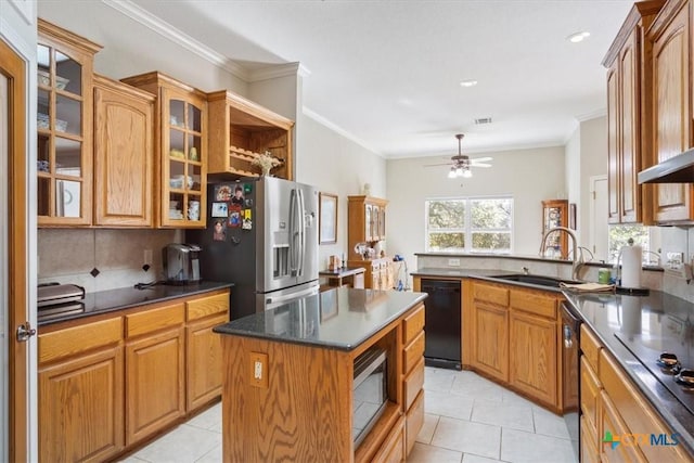 kitchen with ornamental molding, ceiling fan, sink, black appliances, and a center island