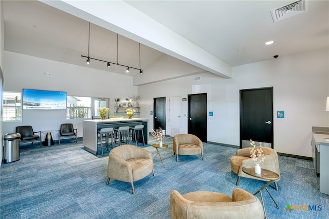 living room featuring baseboards, visible vents, a healthy amount of sunlight, and carpet