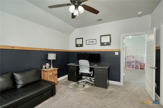 office space with baseboards, a ceiling fan, lofted ceiling, and light colored carpet