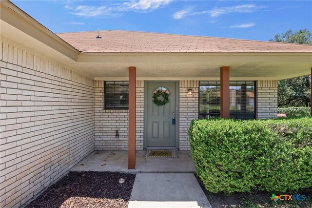 116 Spur Dr, Copperas Cove, TX 76522 - entrance to property with brick siding, a shingled roof, and a porch