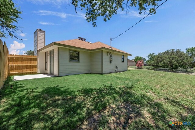 116 Spur Dr, Copperas Cove, TX 76522 - back of property with a fenced backyard, a patio, and a chimney