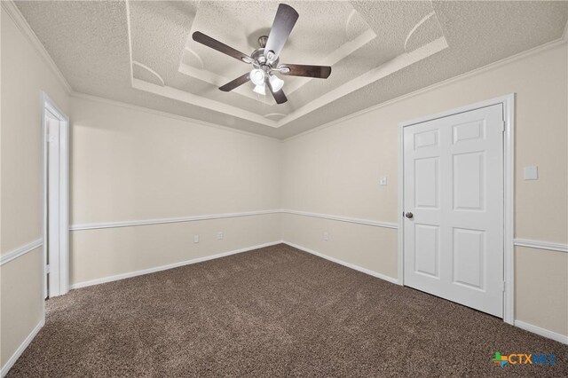 116 Spur Dr, Copperas Cove, TX 76522 - unfurnished bedroom with a textured ceiling, a tray ceiling, carpet flooring, ornamental molding, and ceiling fan