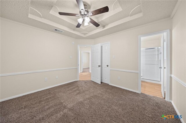 116 Spur Dr, Copperas Cove, TX 76522 - unfurnished bedroom featuring a raised ceiling, carpet floors, a textured ceiling, crown molding, and connected bathroom