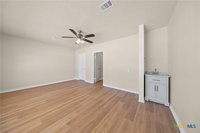 116 Spur Dr, Copperas Cove, TX 76522 - spare room featuring ceiling fan, light wood-type flooring, and a textured ceiling