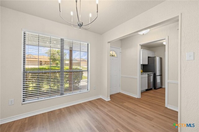 116 Spur Dr, Copperas Cove, TX 76522 - unfurnished dining area with light wood finished floors and a chandelier