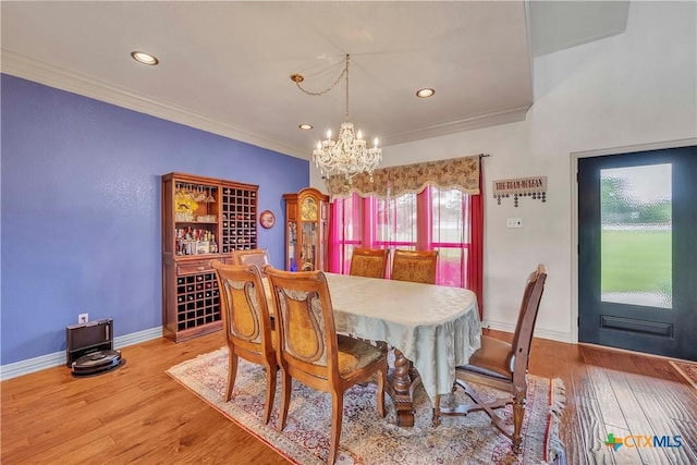 dining area featuring a chandelier, ornamental molding, wood finished floors, recessed lighting, and baseboards