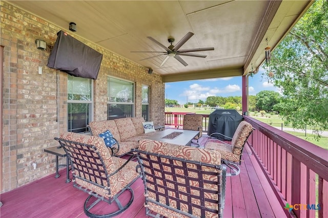 wooden terrace with an outdoor living space with a fire pit, ceiling fan, and a grill
