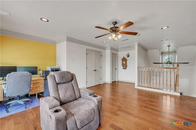 office space featuring a ceiling fan, ornamental molding, light wood-style flooring, and recessed lighting