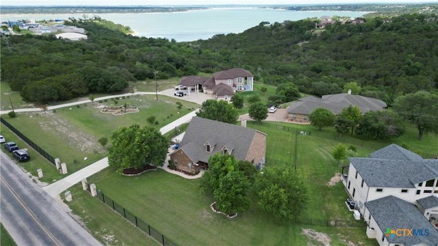 view of property location featuring a heavily wooded area and a large body of water