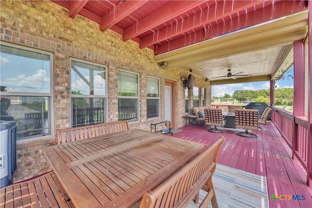 deck with outdoor dining space and a ceiling fan