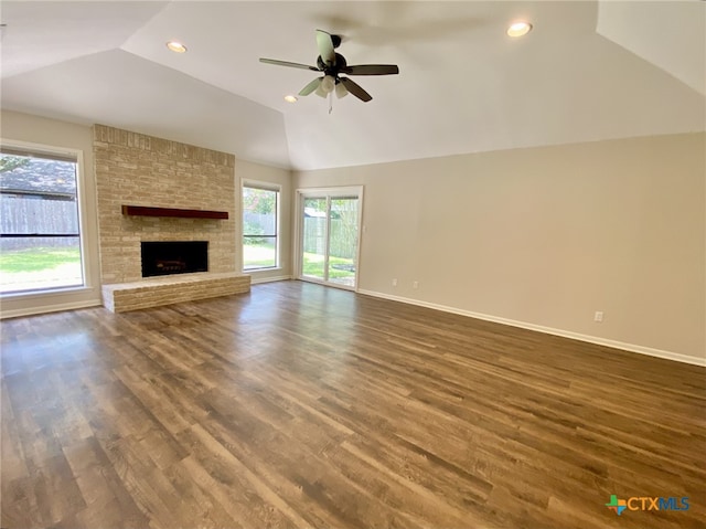 507 Santa Fe, Victoria, TX 77904 - unfurnished living room featuring vaulted ceiling, a ceiling fan, a brick fireplace, dark wood-style flooring, and recessed lighting