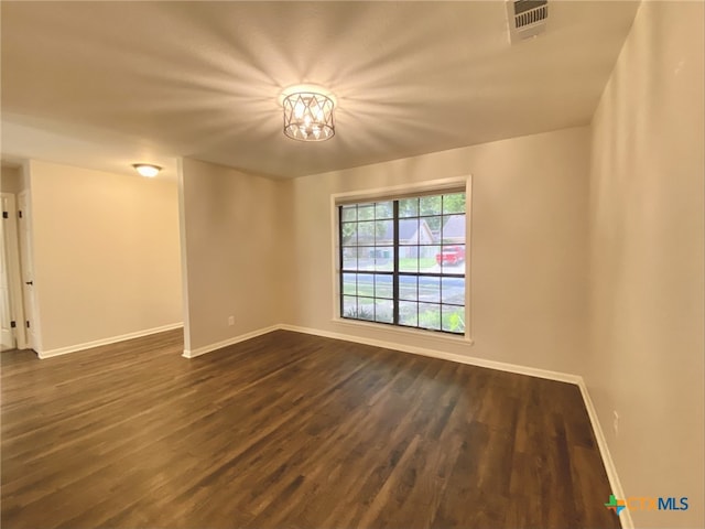 507 Santa Fe, Victoria, TX 77904 - unfurnished room featuring baseboards and dark wood-style flooring