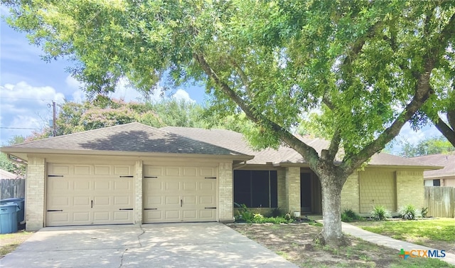 507 Santa Fe, Victoria, TX 77904 - ranch-style house with driveway, an attached garage, roof with shingles, and brick siding