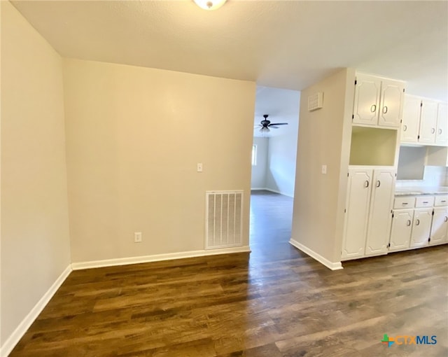 507 Santa Fe, Victoria, TX 77904 - kitchen featuring dark wood-style floors, a ceiling fan, and white cabinetry