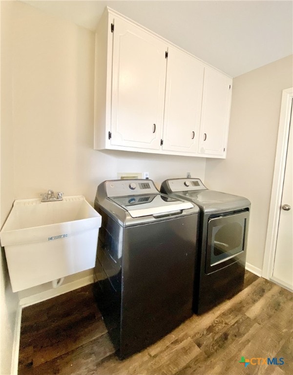 507 Santa Fe, Victoria, TX 77904 - laundry area with cabinet space, separate washer and dryer, and wood finished floors