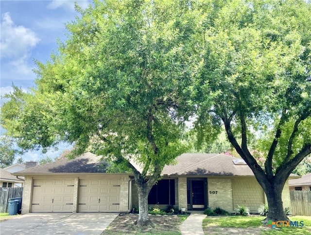 507 Santa Fe, Victoria, TX 77904 - ranch-style house with a garage, concrete driveway, and brick siding