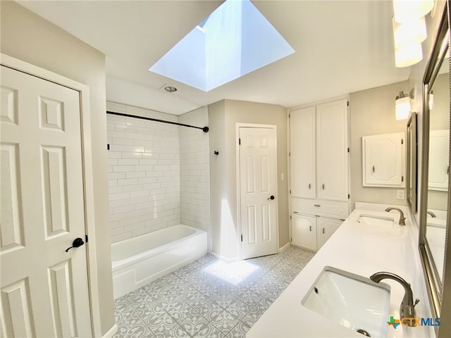 507 Santa Fe, Victoria, TX 77904 - bathroom featuring a skylight, double vanity, washtub / shower combination, and tile patterned floors