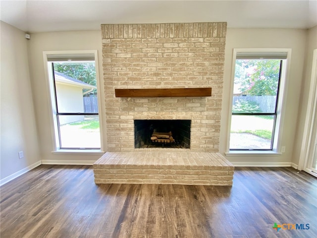 507 Santa Fe, Victoria, TX 77904 - unfurnished living room featuring wood finished floors and a brick fireplace