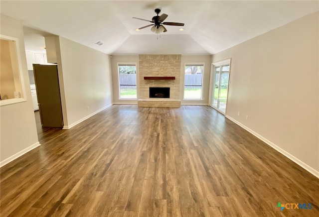 507 Santa Fe, Victoria, TX 77904 - unfurnished living room with ceiling fan, dark wood-style floors, a fireplace, and lofted ceiling
