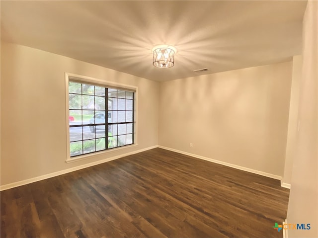 507 Santa Fe, Victoria, TX 77904 - spare room featuring dark wood-style flooring and a chandelier