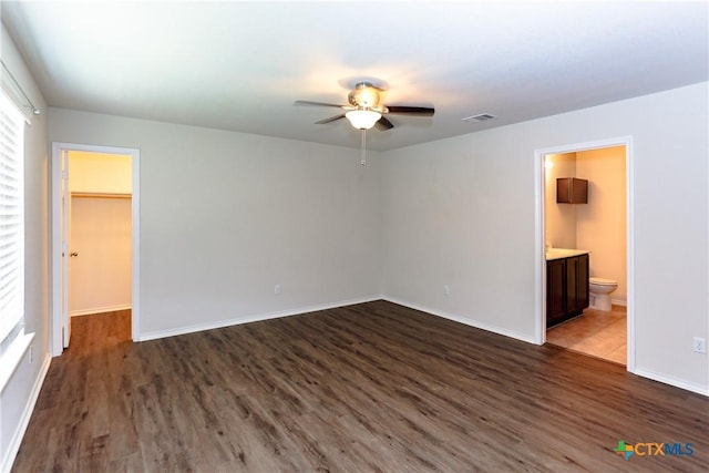 1321 Cozy Creek Dr, Temple, TX 76502 - unfurnished bedroom featuring dark wood finished floors, a spacious closet, ensuite bathroom, and ceiling fan