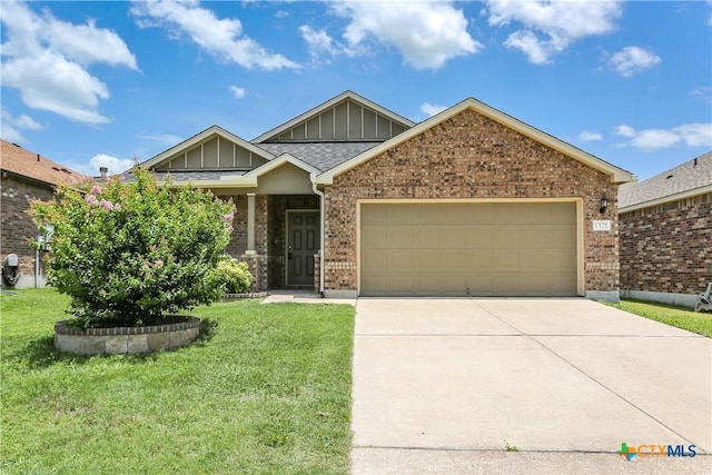 1321 Cozy Creek Dr, Temple, TX 76502 - craftsman house with an attached garage, board and batten siding, driveway, brick siding, and a front lawn