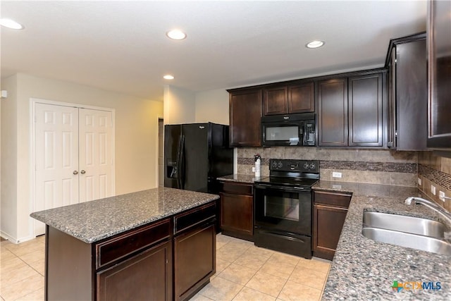 1321 Cozy Creek Dr, Temple, TX 76502 - kitchen with black appliances, light tile patterned flooring, backsplash, dark stone countertops, and recessed lighting